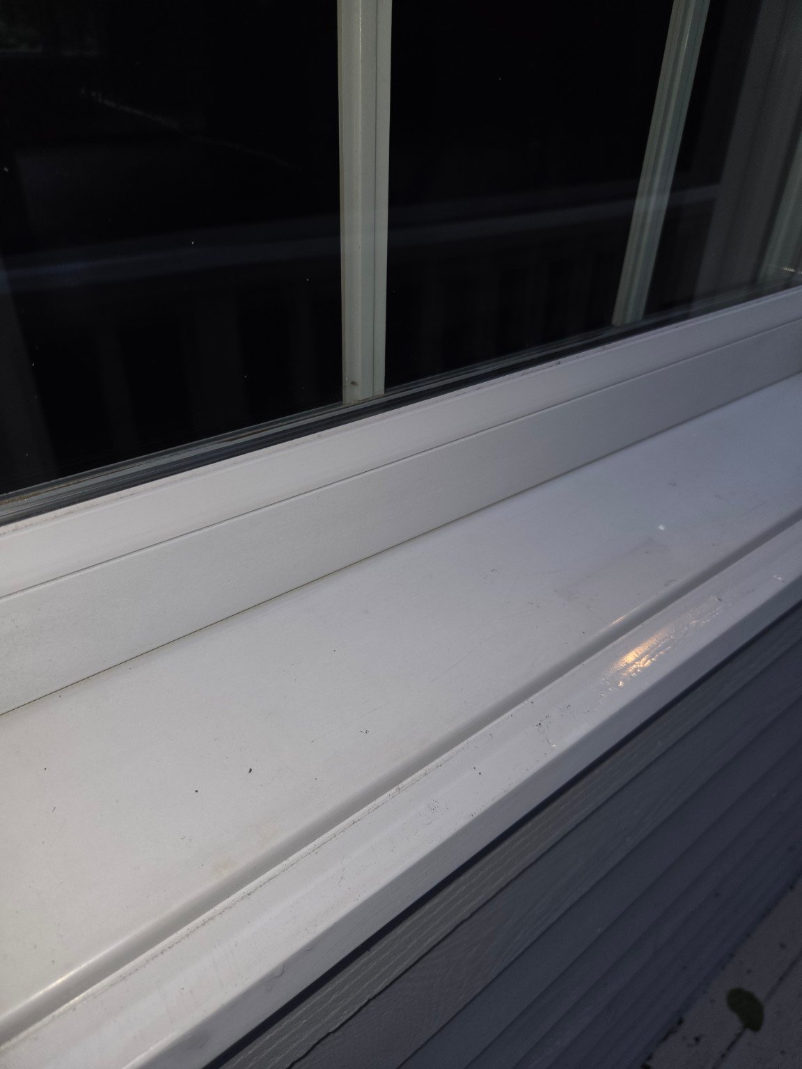 Clean residential window frame and sill after professional window cleaning